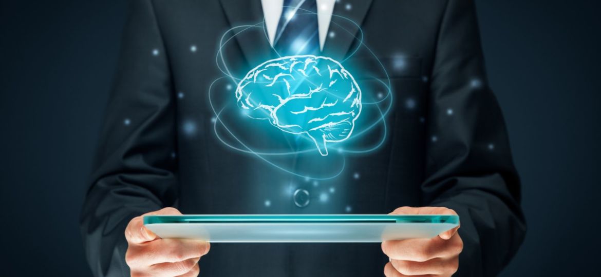 tablet with a brain graphic hovering above it
