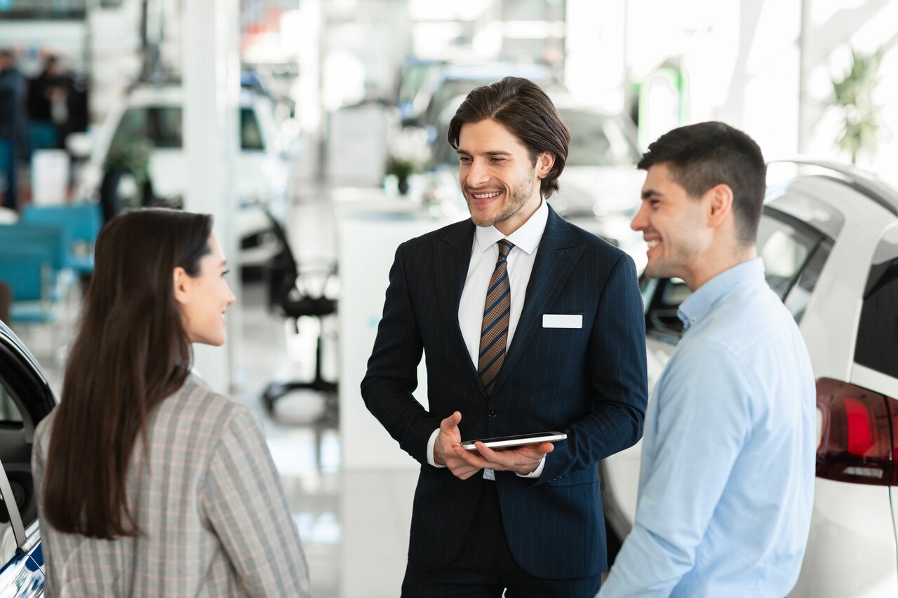 People chatting at an Automotive Dealership