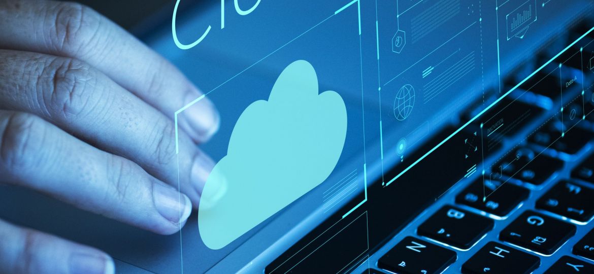 Woman scrolling on a laptop