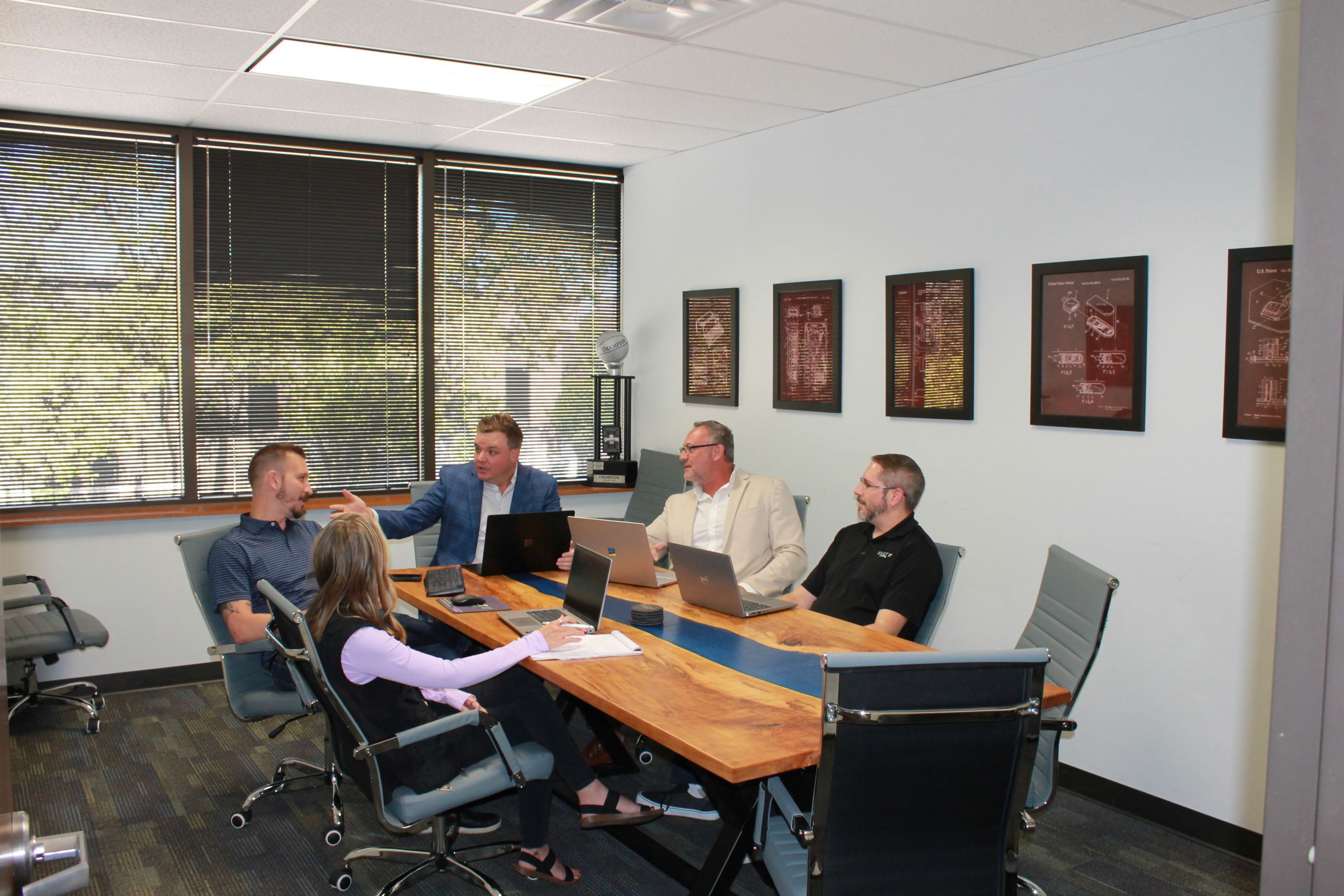IMG_2061-scaled (1) Exact IT Team sitting at the conference table.